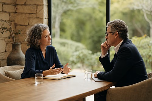 Two professionals in discussion at a leadership retreat.